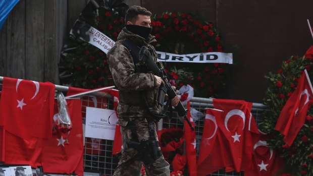 A Turkish special security force member patrols near the scene of the nightclub attack.