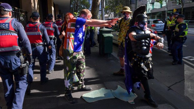 Police and protesters parodying the far-right were outside court on Monday. 