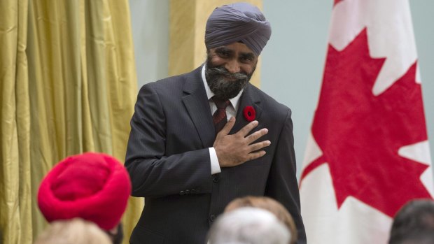 Defence Minister Harjit Singh Sajjan reacts after being sworn in at Rideau Hall in Ottawa. 