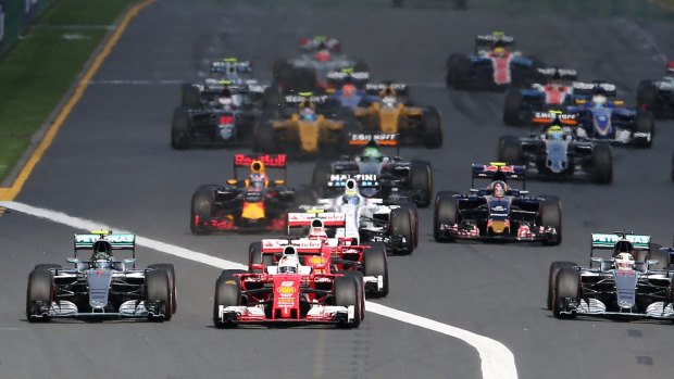 Vettel's Ferrari leads the field into turn one to get the procession under way.