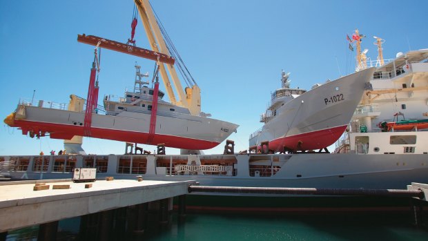 61901001728.jpg 

CAPTION   Petrol boats made for the Yemeni Government are loaded onto a mother ship for transport to the Middle East. The patrol boats were made by Austal in Perth.