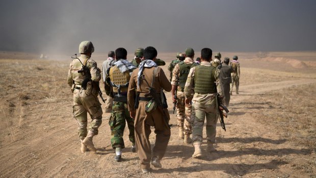 Kurdish peshmerga soldiers outside the village of Tiskharab.