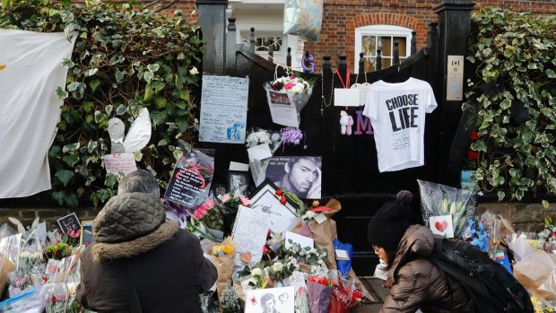 People mourn outside the home of George Michael in London.