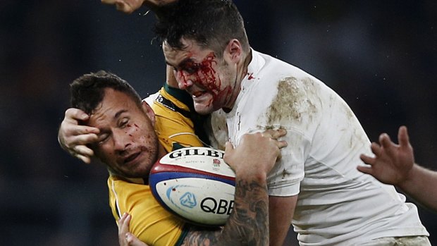 Rugged tour: Quade Cooper is smashed in a tackle by Brad Barritt.