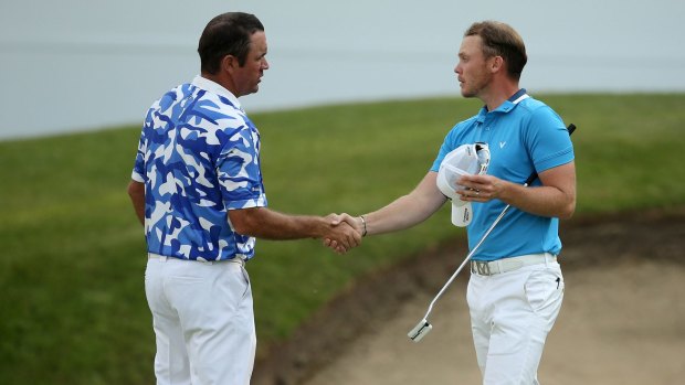 Friendly rivals: England's Danny Willett shakes hands with Scott Hend after finishing the third round  at the Wentworth Club.