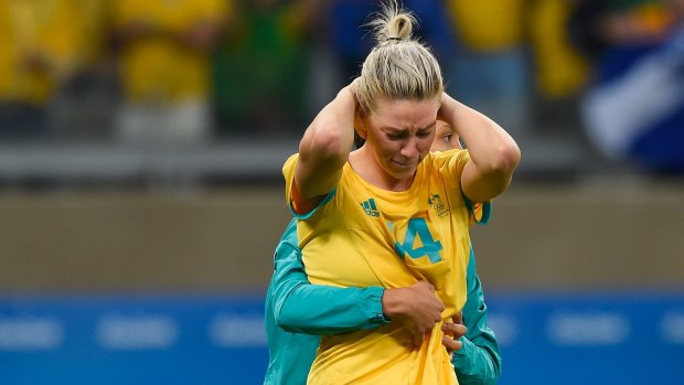 Heartbreak: Alanna Kennedy is comforted after missing the final penalty in the Matildas' loss to Brazil.