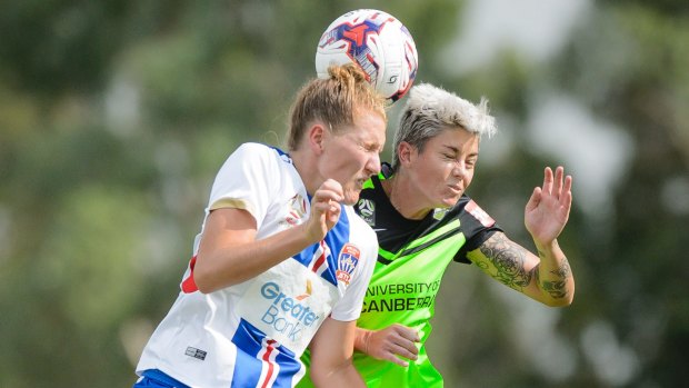 Newcastle Jets defender Natasha Prior and Canberra United forward Michelle Heyman compete for a high ball. Photo: Sitthixay Ditthavong