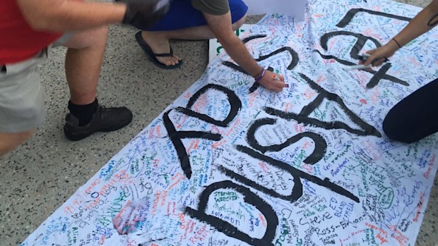 Hundreds signed a banner for baby Asha, which would be taken to Immigration Minister Peter Dutton's office later in the week.