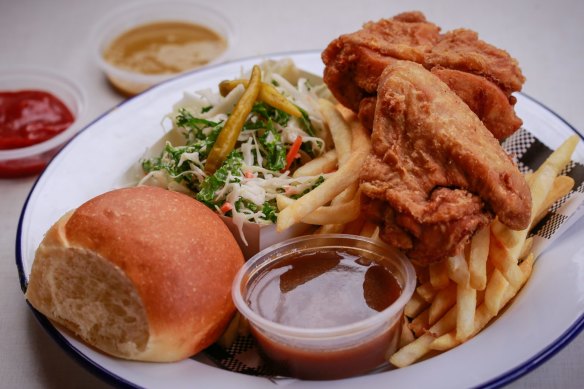 Fried chicken served with  fries, coleslaw, bread and gravy.