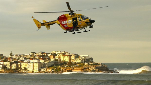 A rescue helicopter searches for a missing person at Bondi beach on Monday.