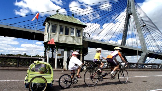 A family crosses the Glebe Island Bridge during a charity ride in 2000. 