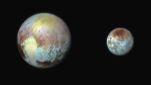 A combination image released by NASA on July 13 shows Pluto, left, and its moon, Charon, with differences in surface material and features depicted in exaggerated colours made by using different filters on a camera aboard the New Horizons spacecraft.