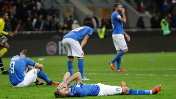 Italy's Ciro Immobile (front), and Italy's Andrea Belotti (left) react to their team's elimination.