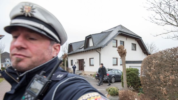 Police stand in front of the residence of the parents of Andreas Lubitz, co-pilot on Germanwings flight 4U9525, on March 26, 2015 in Montabaur, 