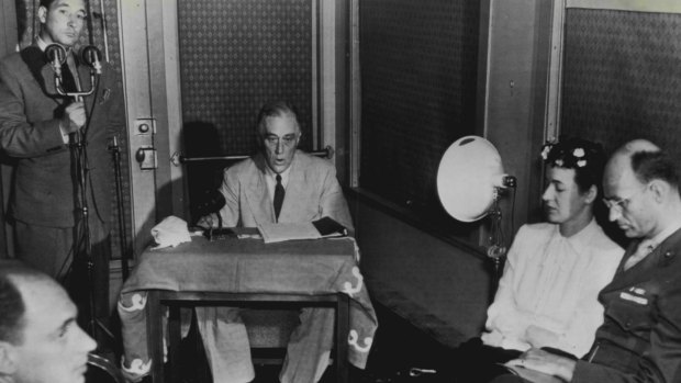 Franklin D Roosevelt, seated centre, speaks on the radio in 1944.