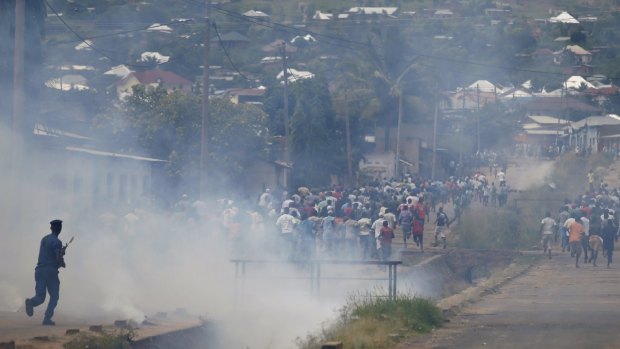 Protesters flee as police fire tear gas during a protest in Bujumbura on Tuesday. 