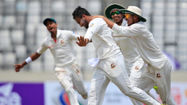 Jubilation: Teammates congratulate Bangladesh's Shakib Al Hasan after the dismissal of Glenn Maxwell.