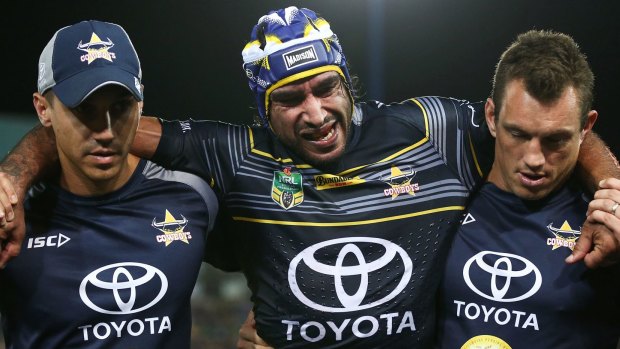 Body blow: Johnathan Thurston is helped off the field.