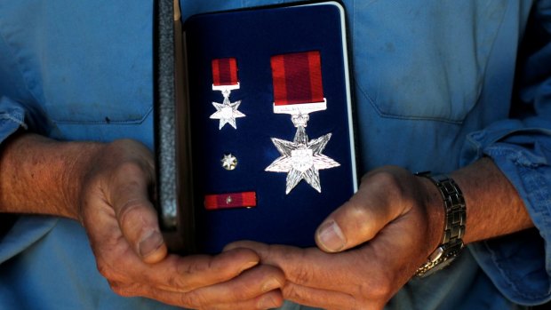 Lauren Munro, a Bali bombing survivor, holds his Star of Courage medal.