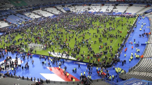 Spectators invade the pitch of the Stade de France stadium after the international friendly soccer France against Germany.