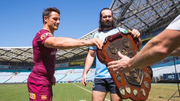 Hand it over: Queensland's Cooper Cronk and the Blues Aaron Woods both want that Origin shield.