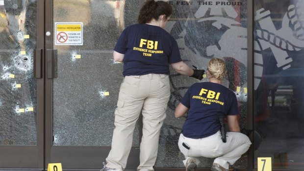 FBI agents gather evidence at the Armed Forces Career Centre in Chattanooga, Tennessee.