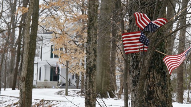 Small American flags fly in front of the Warmbier family home in Wyoming, Ohio, after Otto Warmbier's detention in January. 