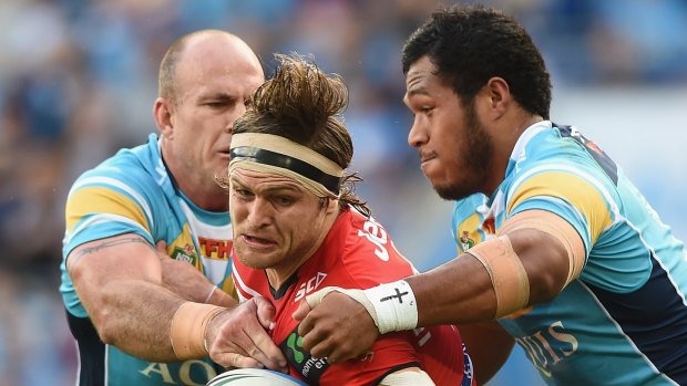 Mitch Rein of the Dragons takes on the Titans defence at Cbus Super Stadium on the Gold Coast.