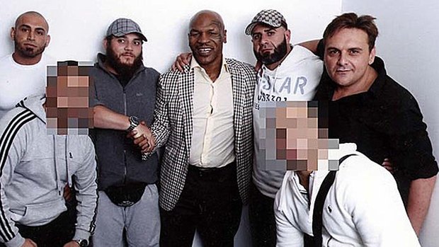 Khaled Sharrouf, third from left, shakes hands with Mike Tyson. George Alex is on the far right wearing a black shirt.