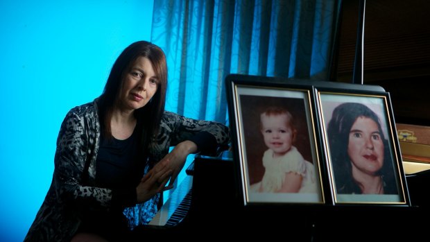 Melissiah Faulkner with photos of her missing younger sister Charmian and mother Louise. 