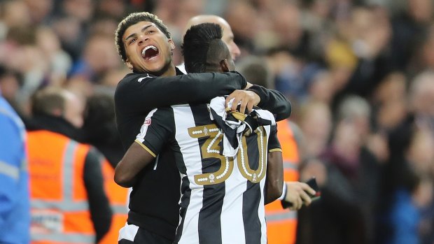 Newcastle United's Christian Atsu celebrates promotion with teammates.