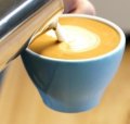 Barista Craig Simon pours the perfect latte.