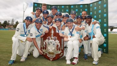 The NSW Blues celebrate their Sheffield Shield triumph at Manuka Oval.