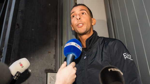 Mohamed Abdeslam addresses the media at his house in the Molenbeek neighborhood in Brussels.