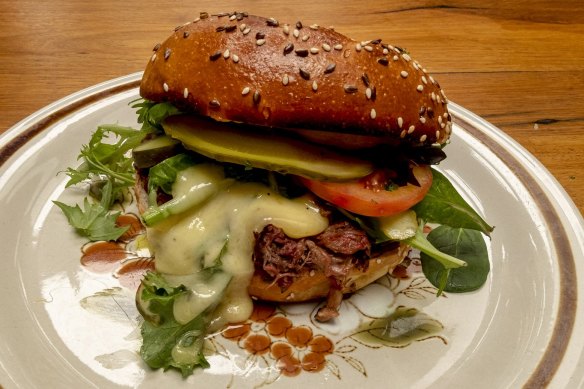 Smoked pulled beef bun with tomato, pickle, cheese, lettuce and horseradish mayo.