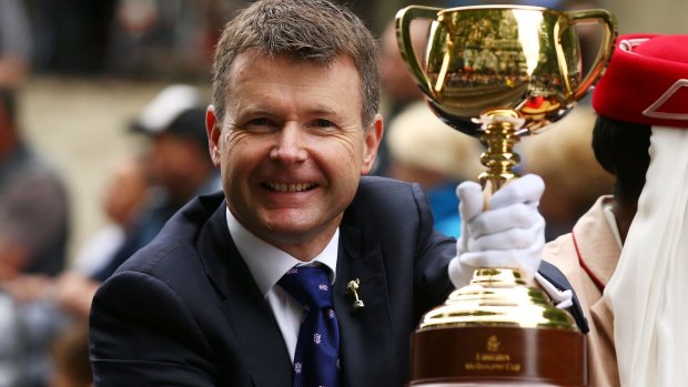  VRC chairman Michael Burn holds the Melbourne Cup.
