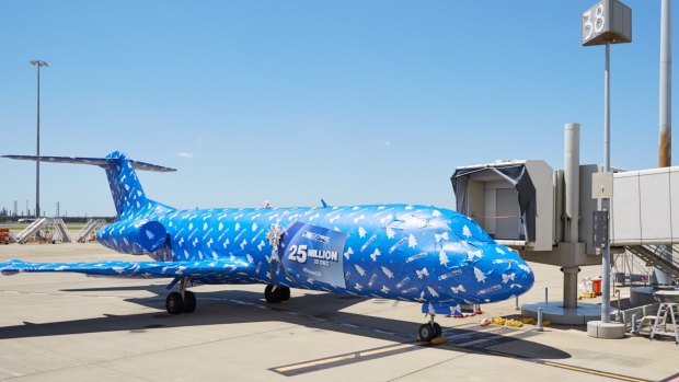 An Alliance Airlines Fokker 70 was wrapped in Christmas paper in a Powerball promotion at Brisbane Airport on Wednesday, December 21, 2016.