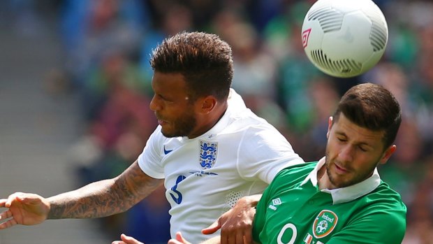 Ryan Bertrand of England competes for possession against Shane Long of Ireland.
