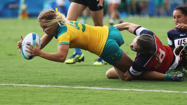 Emma Tonegato of Australia dives to score the try against Carmen Farmer of the United States during the Women's Pool A rugby match.