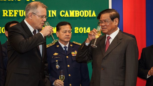 Immigration Minister Scott Morrison and Cambodian Interior Minister Sar Kheng toast their deal in September last year.