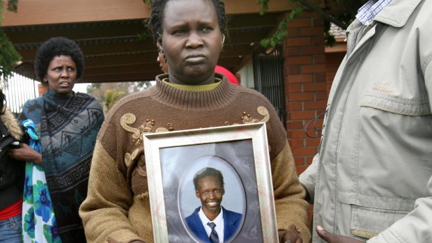 Martha Ojulo holds a photo of her son, Liep Gony.