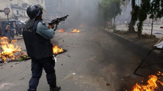 A police officer shoots rubber bullets during a clash with Islamic activists in Dhaka in 2013: the government has tried to crack down on hardline Islamist groups.