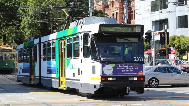A tram travels down Victoria Parade.