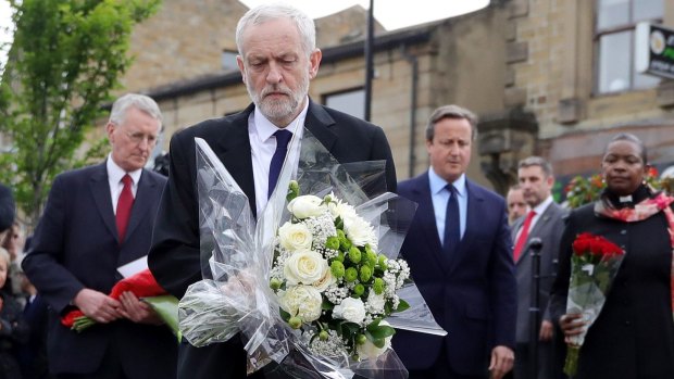 Labour leader Jeremy Corbyn, front, is flanked by the MP for Leeds Central Hilary Benn, Prime Minister David Cameron and the Chaplain to the Speaker of the House of Commons Reverend Rose Josephine Hudson-Wilkin as they lay flowers in memory of Jo Cox.