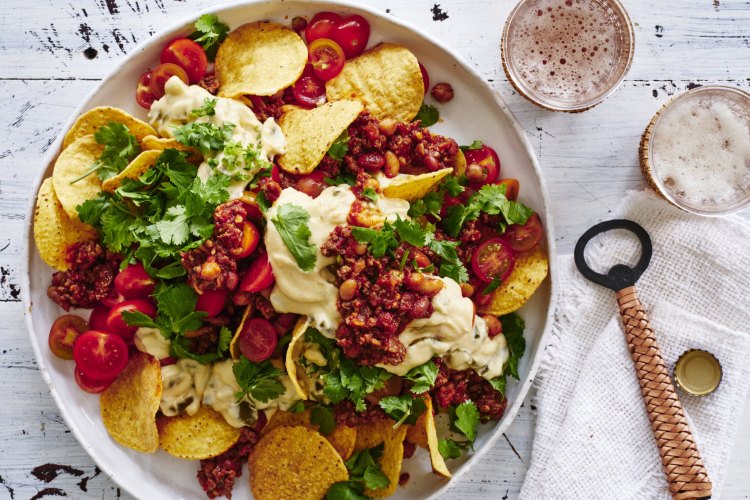 Beef and bean nachos with jalapeno cheese sauce.