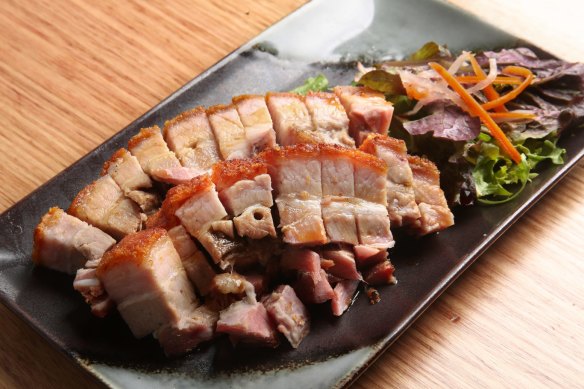 A platter of roasted pork belly with shatter-crisp crackling.