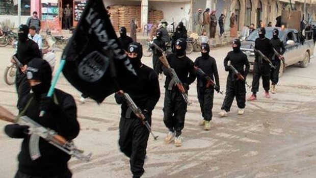 Islamic State fighters march in Raqqa, Syria in 2014.
