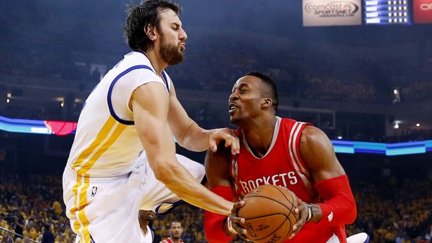 Defensive presence: Golden State's Andrew Bogut goes head to head with Rockets centre Dwight Howard.