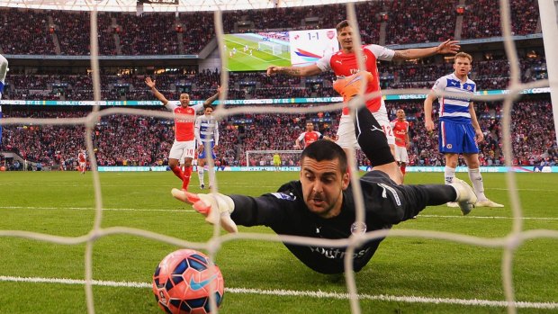 The howler: Adam Federici of Reading stretches for the ball as he fails to stop a shot by Alexis Sanchez of Arsenal.
