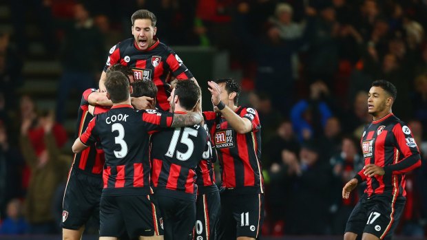Bournemouth players celebrate their team's first goal against Manchester United last season. 